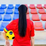 Soccer,Player,Woman,With,A,Soccer,Ball,And,Captain,Armband