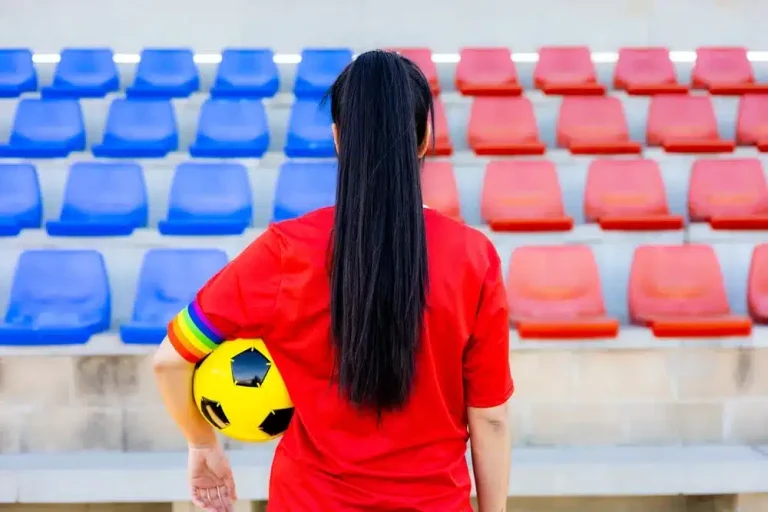 Soccer,Player,Woman,With,A,Soccer,Ball,And,Captain,Armband